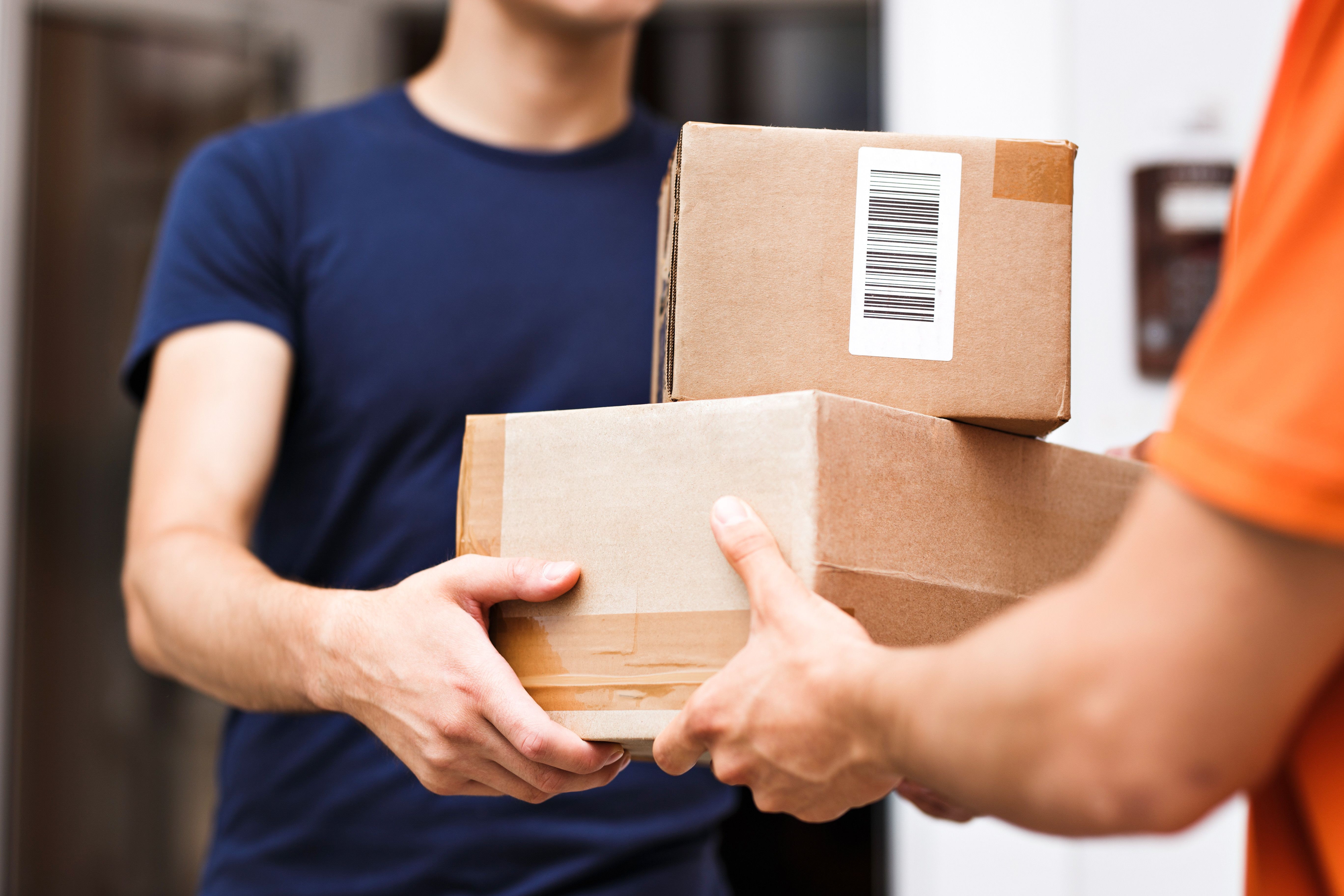 One person handing two parcels to another