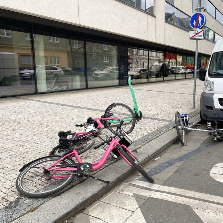 Pink bicycles lying on a sidewalk