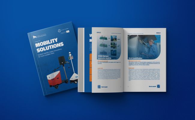 Blue mobility solutions brochures, one closed and one open showing photos and text pages