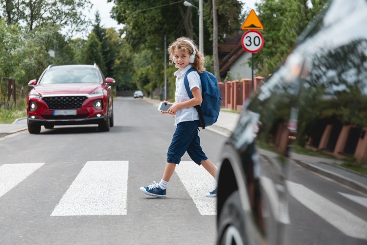 A schoolkid crossing the street