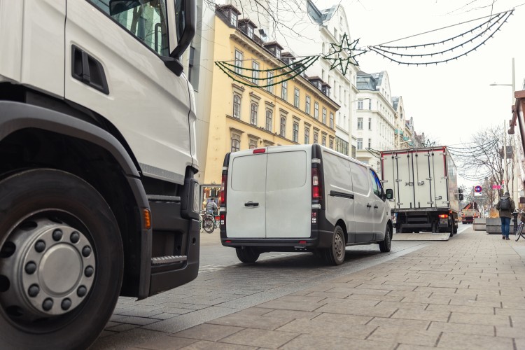 Vans parked in a small European street
