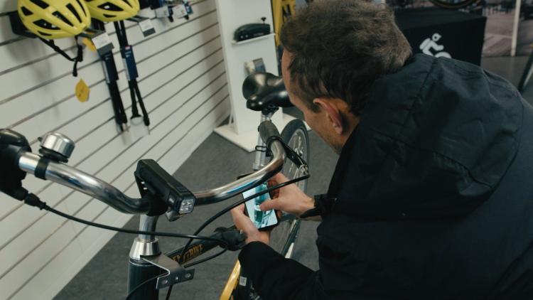 A man scanning the app on a bike 