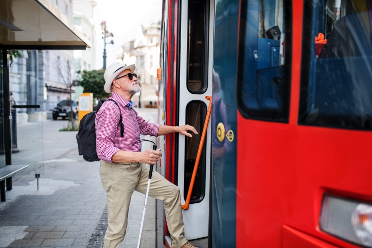 Visually impaired person getting on public transport