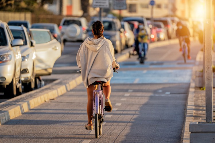 Woman cycling on a separated bike lane