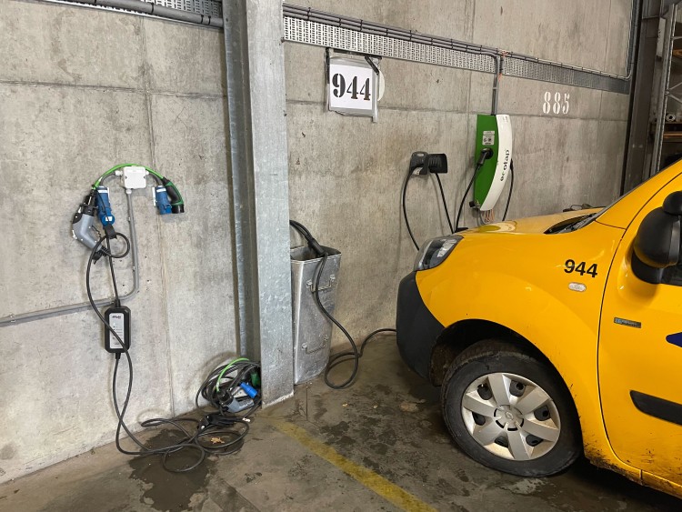 A municipal fleet van plugged in to an EV charger