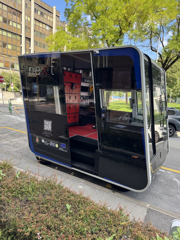 Modular electric vehicle with integrated mobile parcel lockers (ePods) demonstrated in the Padua Living Lab for sustainable last-mile deliveries.