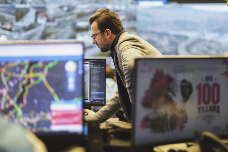 man looking at monitors displaying map