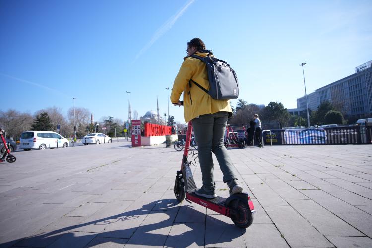 A man riding an electric scooter