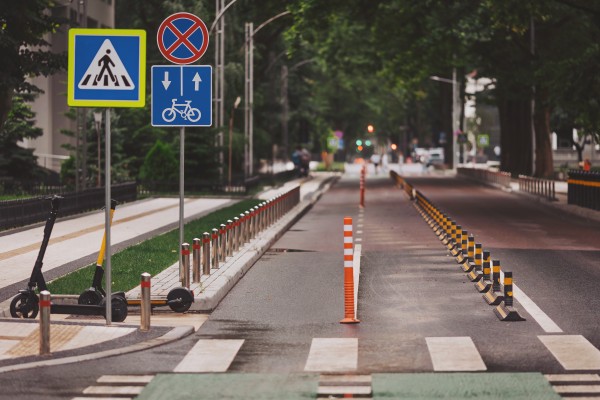 Straight two way cycle lane along side an asphalt road in the middle of city