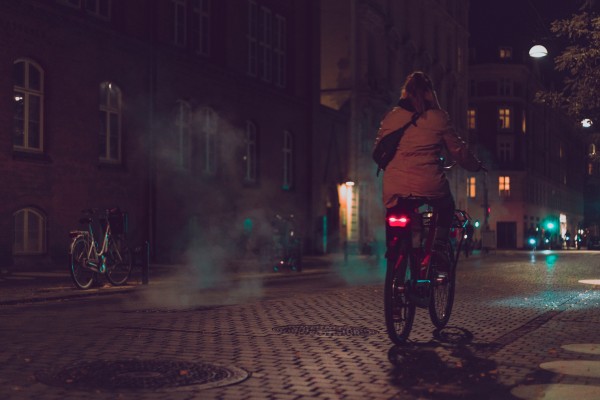 A woman riding a bike during the night