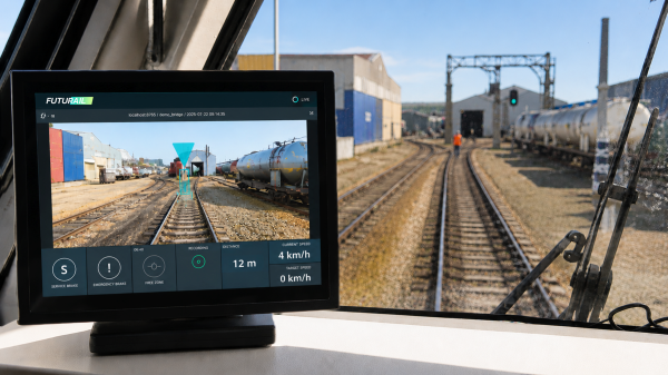 Futurail AR driver-assistance interface in a train cab, overlaying track guidance and speed data on a live camera feed.