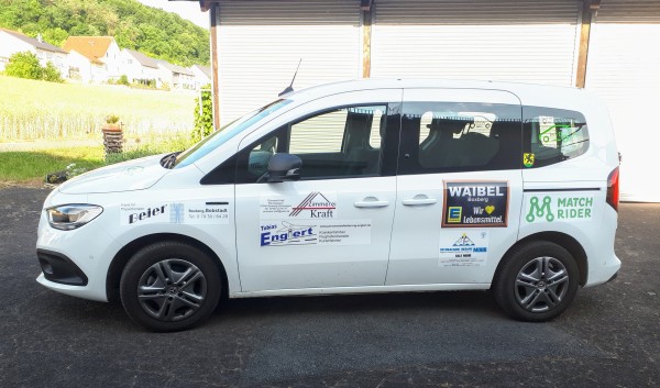 Car with logos including Match Rider logo printed on side.
