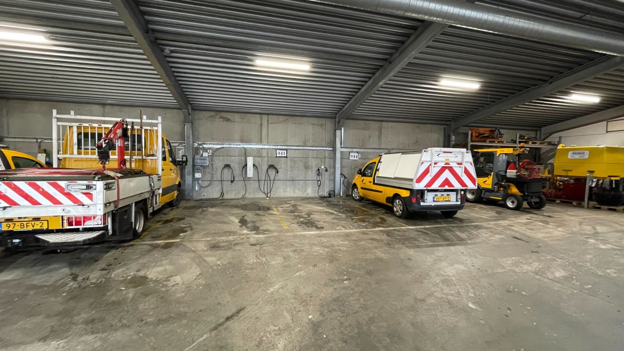 Parked municipal EV fleet vehicles in Venlo depot