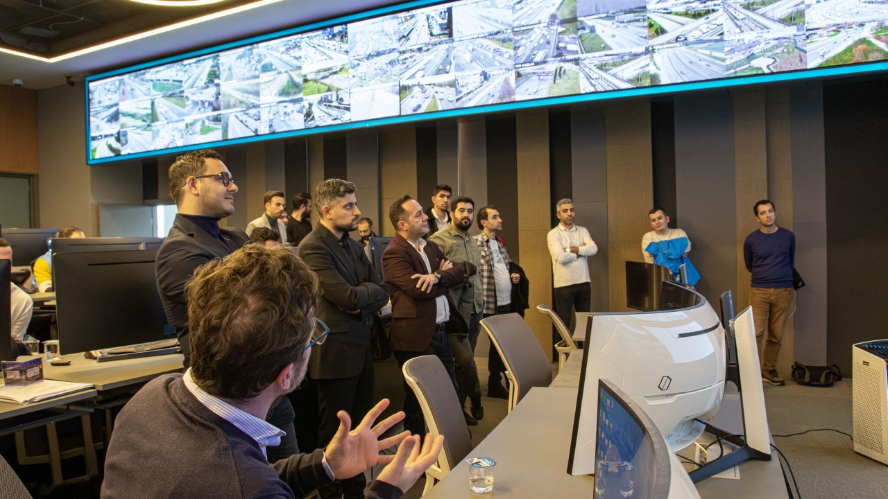 Group of people looking at monitors displaying traffic monitoring software