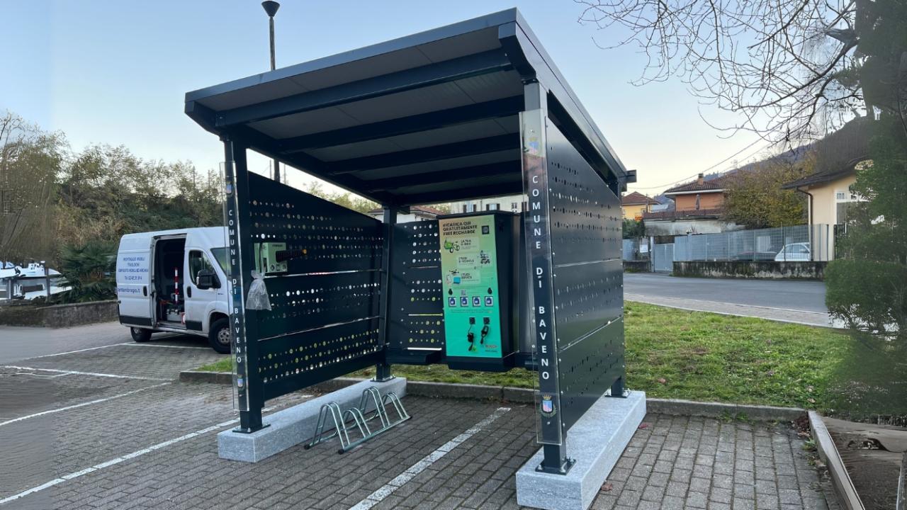 A modern solar-powered shelter with clear signage and easy access to charging stations.