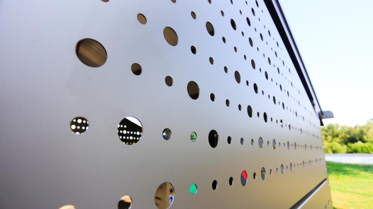 A detailed close-up of the shelter’s perforated panel, showing its modern aesthetic.