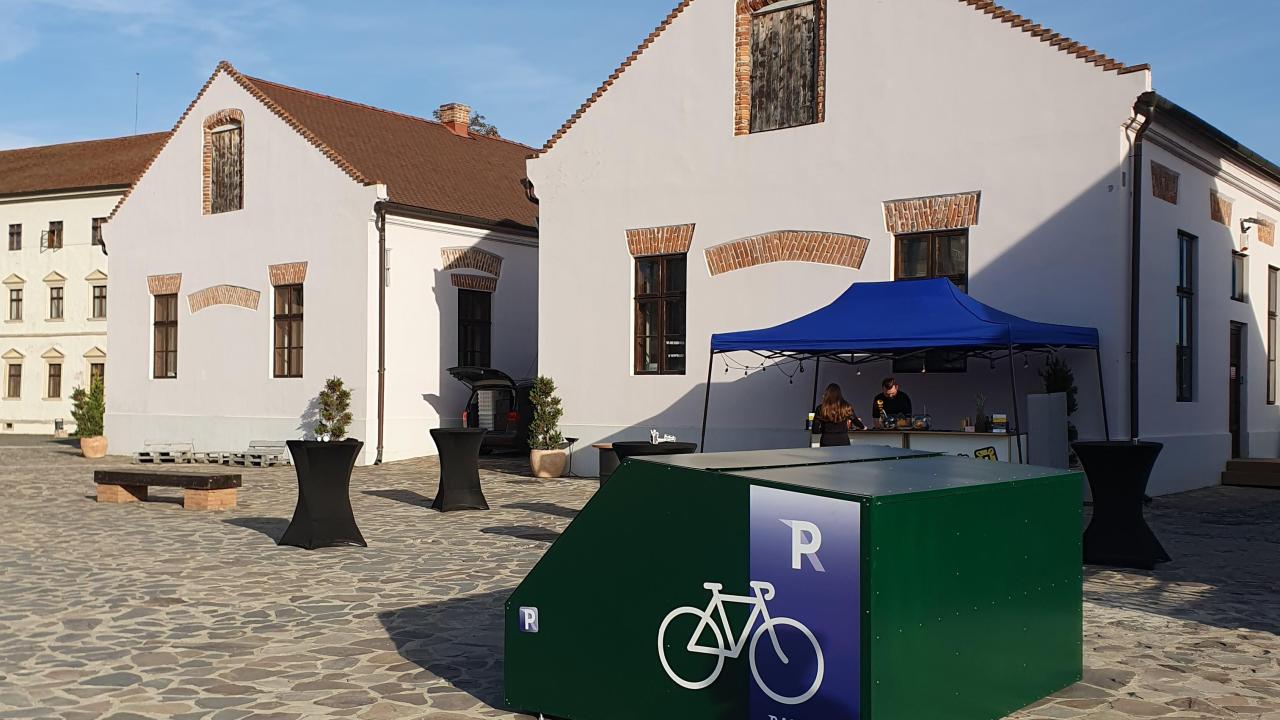 A smart and secure bike shelter, painted in green, placed inside the ancient fortress of Oradea, Romania